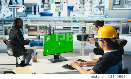 Photovoltaics factory engineer using green screen PC to adjust system parameters. Technician optimizing energy supply in solar panel manufacturing plant using chroma key computer, camera A Photovoltaics factory engineer using green screen PC to adjust system parameters. Technician optimizing energy supply in solar panel manufacturing plant using chroma key computer, camera A 131439924