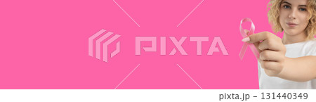 A person holds pink ribbons to promote cancer awareness 131440349