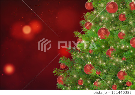 Decorations shine on a beautifully lit Christmas tree 131440385