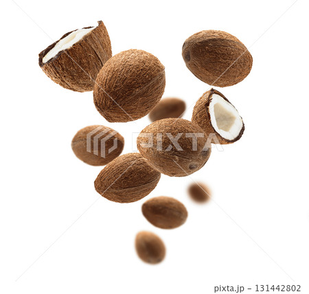 Whole and half cocoanuts levitate on a white background 131442802