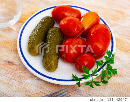 Appetizing pickled cucumbers and tomatoes 131442947