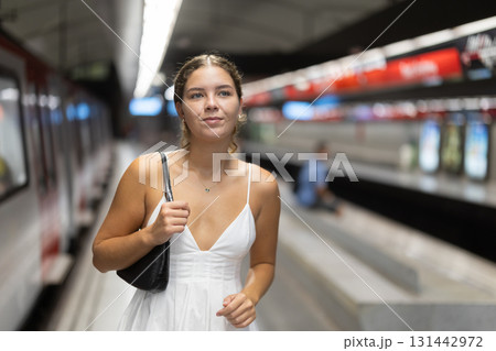 Young girl standing on platform of underground station Young girl standing on platform of underground station 131442972