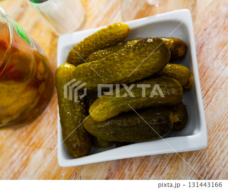 Pickled cucumbers on white plate, homemade preserves Pickled cucumbers on white plate, homemade preserves 131443166
