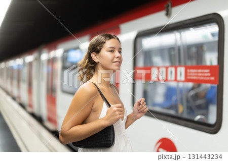 Young girl getting into metro wagon Young girl getting into metro wagon 131443234