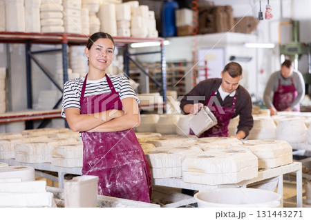 Young woman posing at ceramic factory 131443271