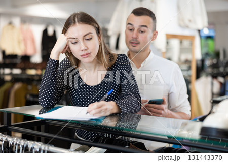 Couple woman and man with phone signing document 131443370