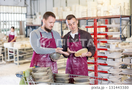 Two men talking about finished dishes 131443380