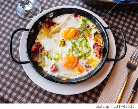 Riojan style eggs casserole with potatoes, bell peppers, sausages Riojan style eggs casserole with potatoes, bell peppers, sausages 131443535