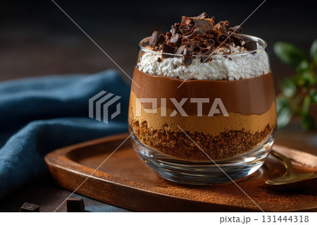 Delicious layered chocolate dessert with whipped cream and chocolate shavings 131444318