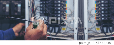 Banner Electrical mechanic technician check wire electric cabinet. Inspector men hands working maintenance service. Electrician circuit repair operation. Men hands fix breaker with copy space Banner Electrical mechanic technician check wire electric cabinet. Inspector men hands working maintenance service. Electrician circuit repair operation. Men hands fix breaker with copy space 131444830