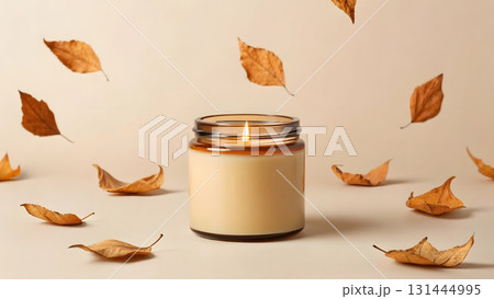 Warm candle glowing amidst scattered dry leaves in a calm autumn setting Warm candle glowing amidst scattered dry leaves in a calm autumn setting 131444995