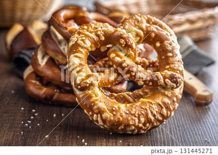 Salted bavarian pretzel on wooden table. Salted bavarian pretzel on wooden table. 131445271