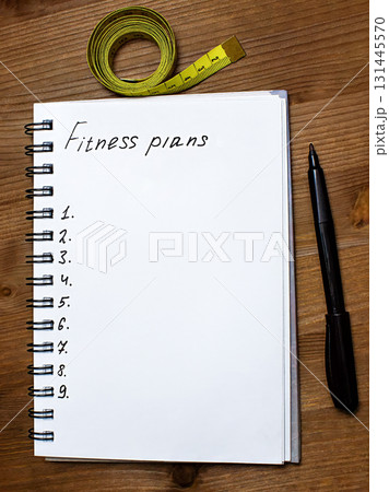 The notebook says Fitness plans, top view The notebook says Fitness plans, top view 131445570