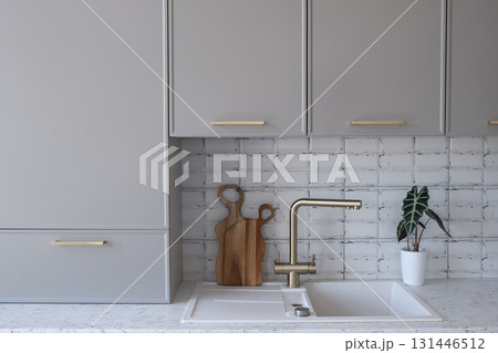 Grey with gold details, modern minimalist kitchen, wooden cutting board, alocasia 131446512