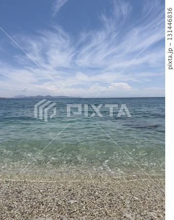 beautiful calm Sea on Pebble Beach and Wispy Clouds under Blue Sky in summer. beautiful calm Sea on Pebble Beach and Wispy Clouds under Blue Sky in summer. 131446836
