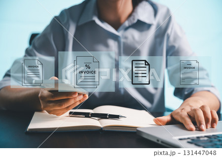 Businesswoman manages electronic statements, digital receipts on virtual screen, utilizing concept of e-invoice, digital billing, online invoice processing as smart e-tax and tax accounting solutions. Businesswoman manages electronic statements, digital receipts on virtual screen, utilizing concept of e-invoice, digital billing, online invoice processing as smart e-tax and tax accounting solutions. 131447048
