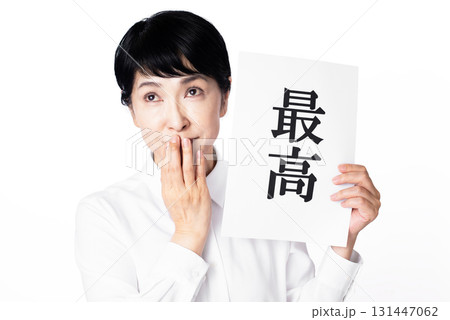 最高と書かれた紙を持ち口元を抑え笑みをこぼすシニア女性 最高と書かれた紙を持ち口元を抑え笑みをこぼすシニア女性 131447062