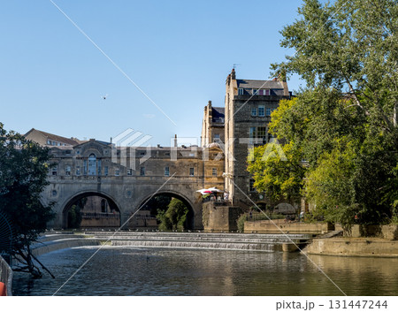 Historic Stone Bridge over Peaceful River Scene 131447244