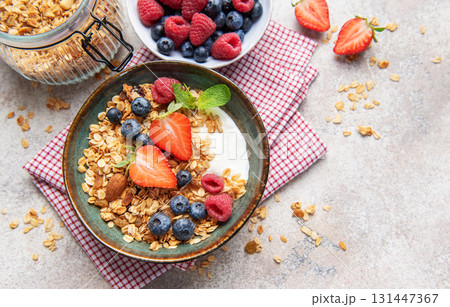 Granola bowl with fresh berries yogurt and nuts Granola bowl with fresh berries yogurt and nuts 131447367