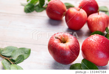 Fresh red gala apples with green leaves  131447384