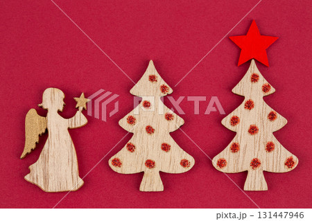 Wooden angel and fir trees 131447946