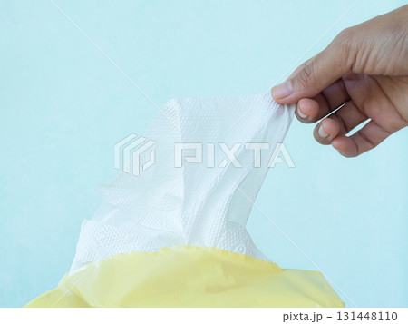 Hand Woman Holding Tissue Paper for Clean hygienic Care, Cleanser Dry, Mokcup Wipe for Cean Hygiene Hand and wipe Cosmetic Beauty on Face, Baby, Packet in Toilet. 131448110