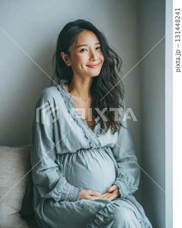 Pregnant asian woman smiling holding baby bump 131448241