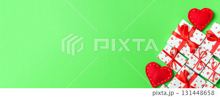 Top view of gift boxes and red textile hearts on colorful background. St Valentine's day concept with copy space 131448658