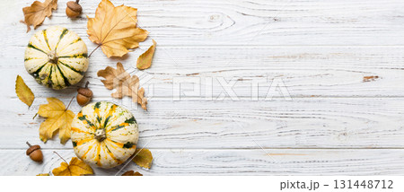 Autumn composition. Pattern made of dried leaves and other design accessories on table. Flat lay, top view Autumn composition. Pattern made of dried leaves and other design accessories on table. Flat lay, top view 131448712