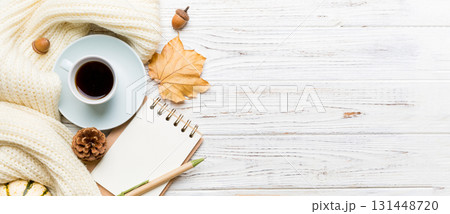 Autumn composition: fallen leaves and craft sketchbook mock up on colored background. Top view. Flat lay with copy space Autumn composition: fallen leaves and craft sketchbook mock up on colored background. Top view. Flat lay with copy space 131448720