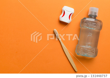 Mouthwash and other oral hygiene products on colored table top view with copy space. Flat lay. Dental hygiene. Oral care products and space for text on light background. concept 131448737