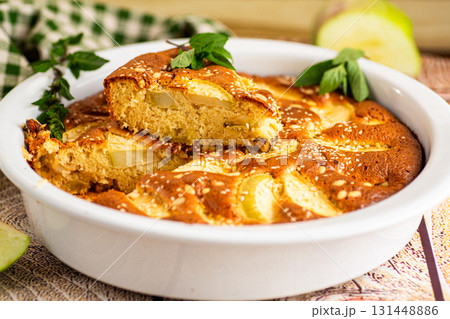 Ruddy apple pie with mint and golden crust close-up 131448886