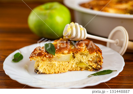 Airy pastries with apple slices and a mint sprig for serving 131448887