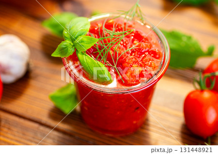 Fresh tomatoes garlic basil and herbs on wooden table Fresh tomatoes garlic basil and herbs on wooden table 131448921
