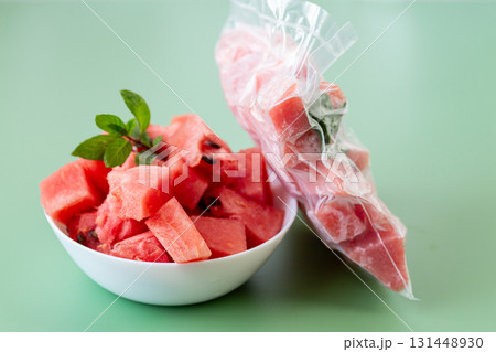 Fresh watermelon cubes in white bowl and frozen package Fresh watermelon cubes in white bowl and frozen package 131448930