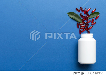 different drugs and health supplement pills poured from a medicine bottle health care and medical top view on colored background different drugs and health supplement pills poured from a medicine bottle health care and medical top view on colored background 131448983