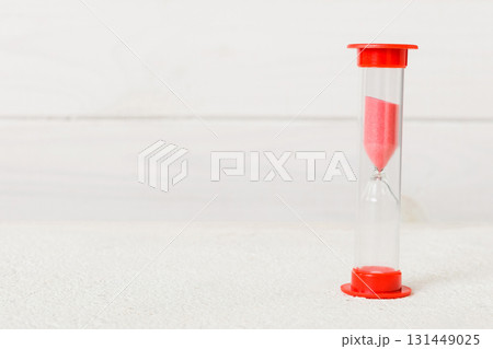 hourglass on the table, sand clock as time passing concept for business deadline, copy space 131449025