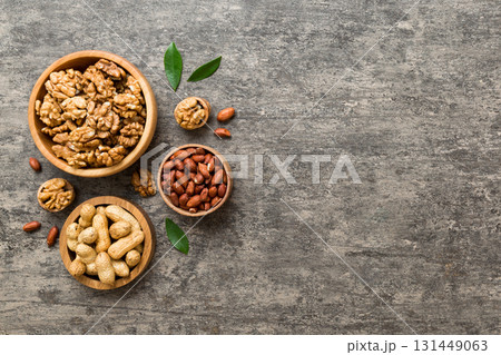 Walnut kernel halves, in a wooden bowl. Close-up, from above on colored background. Healthy eating Walnut concept. Super foods with copy space 131449063