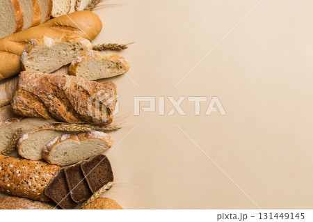 Homemade natural breads. Different kinds of fresh bread as background, top view with copy space Homemade natural breads. Different kinds of fresh bread as background, top view with copy space 131449145
