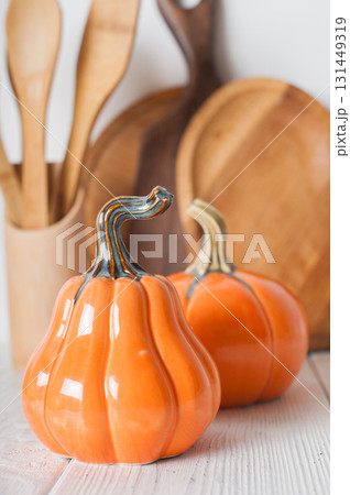 Autumn Kitchen Decor with Wooden Utensils and Ceramic Pumpkins Autumn Kitchen Decor with Wooden Utensils and Ceramic Pumpkins 131449319