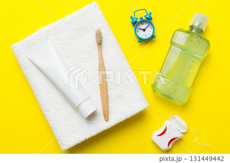 toothpaste and toothbrush top view with copy space on colored background. Flat lay. Dental hygiene. Oral care products on light background. Body care concept 131449442