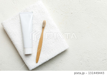 toothpaste and toothbrush top view with copy space on colored background. Flat lay. Dental hygiene. Oral care products on light background. Body care concept 131449443