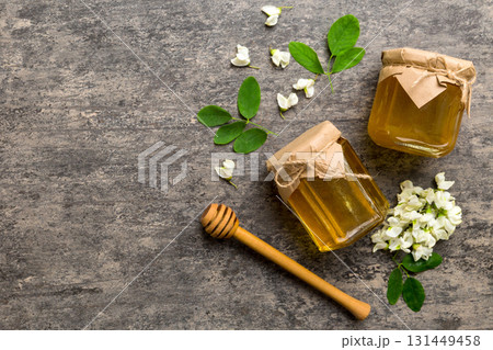 honey jar with acacia flowers and leaves. fresh honey top view flat lay honey jar with acacia flowers and leaves. fresh honey top view flat lay 131449458