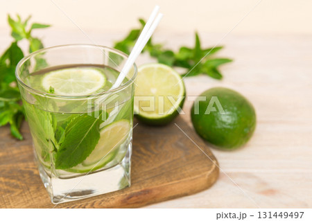 Mojito cocktail. Refreshing mojito cocktail with lime, lemon and mint in a tall glass with a stick 131449497