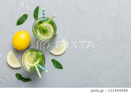 Caipirinha, Mojito cocktail, vodka or soda drink with lime, mint and straw on table background. Refreshing beverage with mint and lime in glass top view flat lay 131449499