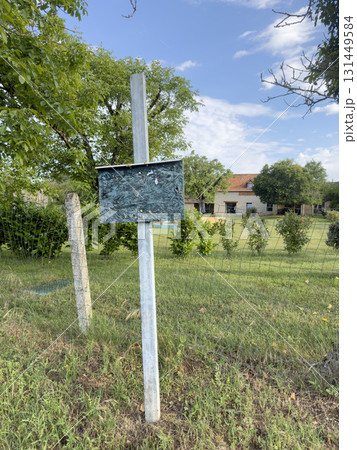 blank  notice board on garden of village house in a rural area 131449584