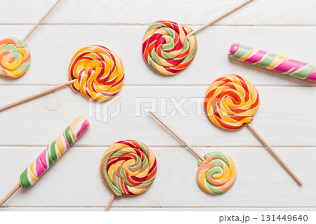 Set of colorful lollipops on colored background. Summer concept. Party Happy Birthday or Minimalist Concept Set of colorful lollipops on colored background. Summer concept. Party Happy Birthday or Minimalist Concept 131449640