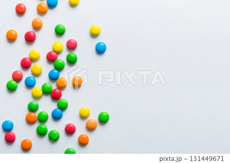 Mixed collection of colorful candy, on colored background. Flat lay, top view. frame of colorful chocolate coated candy 131449671