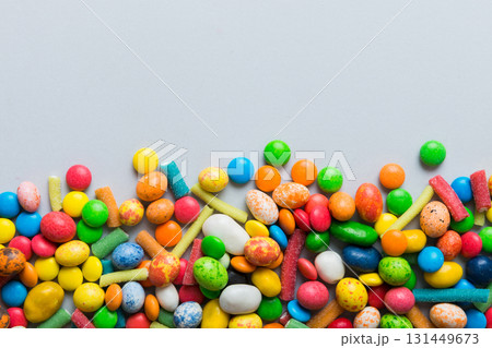 Mixed collection of colorful candy, on colored background. Flat lay, top view. frame of colorful chocolate coated candy Mixed collection of colorful candy, on colored background. Flat lay, top view. frame of colorful chocolate coated candy 131449673