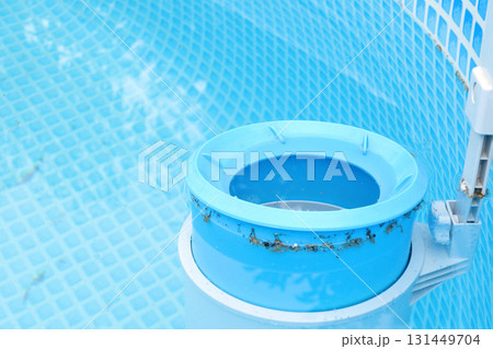 Top view of the blue skimmer for cleaning the pool in clear water. Contaminated pool cleaning concept Top view of the blue skimmer for cleaning the pool in clear water. Contaminated pool cleaning concept 131449704